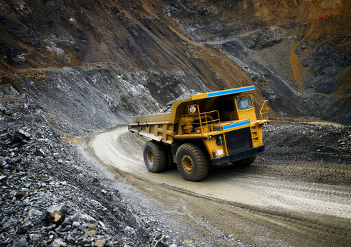 Large Dumptruck Driving On Uphill Track Through Quarry