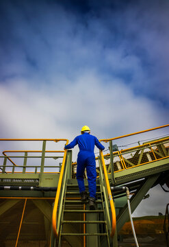 Back view of man walking up outside staircase at quarry