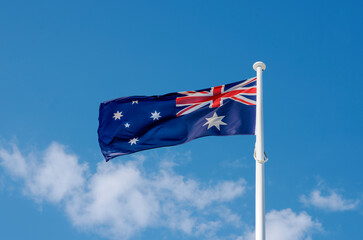 Close up of australian flag flapping in the breeze against blue sky