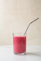 Fruits smoothie in glass with straw copy space