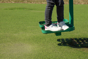 Child walks on playground. Active pastime on the simulator in the fresh air