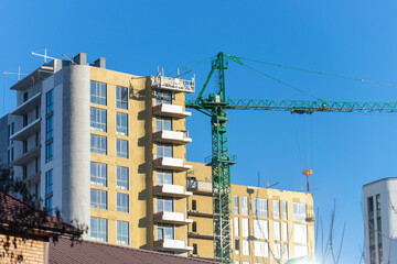 Installation of external wall thermal insulation with rock wool. Exterior passive house wall heat...