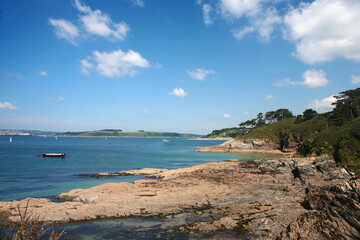 Fototapeta na wymiar View up the Fal estuary from St. Anthony's Head, Cornwall, UK: Carricknath Point, Castle Point and Falmouth beyond