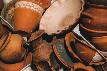 Vintage, vintage clay pots are piled on top of each other. Collection of baked clay tableware....