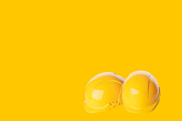Close up of Yellow building safety helmet hard hat isolated on yellow background. poster concept Always use correct PPE Space  for text