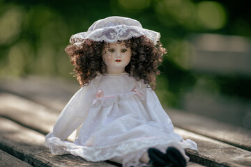 Fototapeta na wymiar Amazing realistic vintage porcelain doll, toy with brown eyes, selective focus