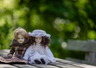 Amazing realistic vintage porcelain dolls, toys on green background