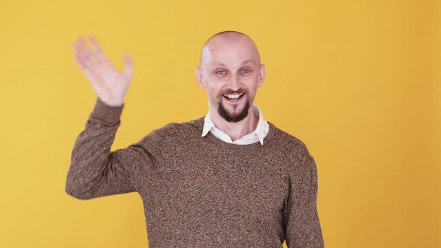 Hello gesture. Welcoming greeting. Boomerang animation. Saying hey. Friendly excited cheerful funny guy waving hand hi gif loop isolated on orange empty space background.