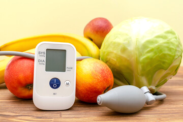 Tonometer and glucose meter,bunch of fresh vegetables,fruits, proper nutrition, healthy lifestyle,...