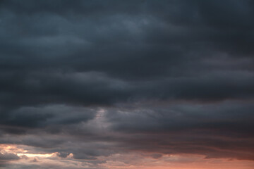 Thunderstorm dramatic clouds during evening sunset.