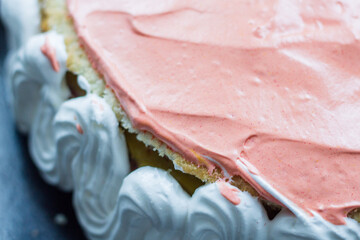 delicious homemade cake. pink and white cream with biscuit. homemade baking.