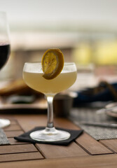 Bird of Youth cocktail in a dinner setting with blurred background. 