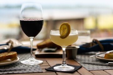 Bird of Youth cocktail in a dinner setting with blurred background.