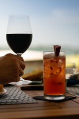 summer n smoke cocktail in a dinner setting with a blurred background