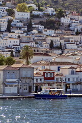 Fototapeta na wymiar City of Hydra, Greece, rising up on a hill above the harbor