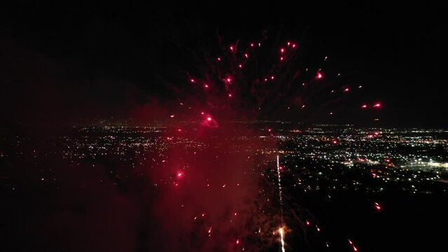 Aerial view of the 4th of July celebration with fireworks exploding in the air after dark
