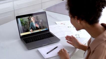Remote negotiations of colleagues on online video conference, brainstorm. Smart african american girl talking on video call with her caucasian successful financial business mentor using laptop