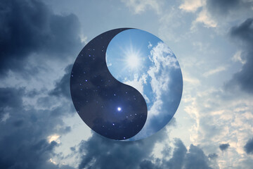 Ying Yang symbol against cloudy sky. Feng Shui philosophy - obrazy, fototapety, plakaty