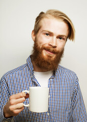 Good morning, man holding a cup tea. Morning concept. Handsome bearded male holds cup of coffee, tea.
