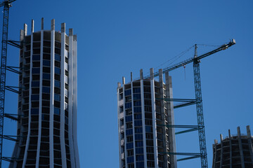 T.ower crane at construction of new multi-storey house