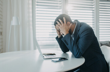 Depressed businessman man counting euro money working on computer at office desk, inflation concept.