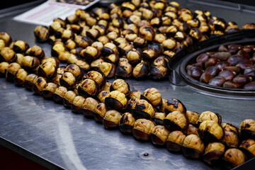 Fried chestnuts on the street. Street food. Roasted chestnuts.