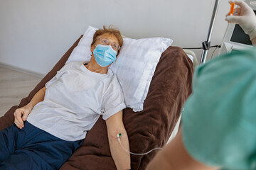 Nurse putting a drip in the arm of her patient in modern medical clinic. High quality photo