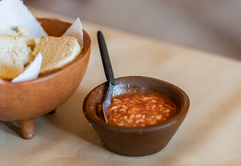 Spicy tomato sauce with onions in a rustic clay pot. Typical Latin America food