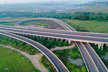 Fototapeta na wymiar Aerial view on the new road construction site at Tambun. Bekasi, Indonesia, June 21, 2022