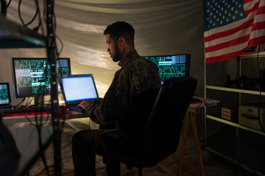 American hacker in military unifrorm on dark web, cyberwar concept.