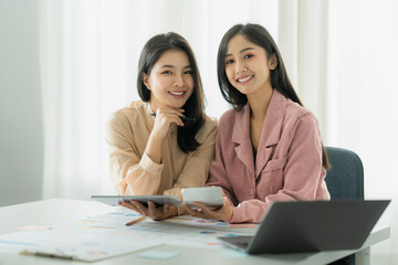 Portrait of Asian Businesswoman and Accountant checking data document on digital tablet for investigation of corruption account. Anti Bribery concept.