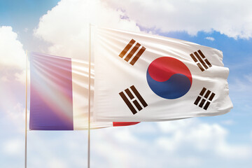 Sunny blue sky and flags of south korea and france