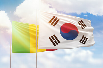 Sunny blue sky and flags of south korea and mali