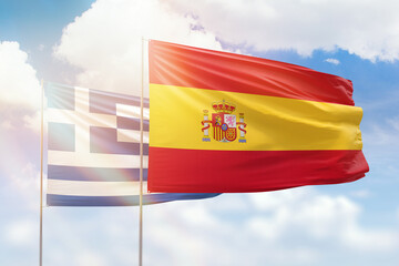 Sunny blue sky and flags of spain and greece