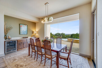 a luxury dining room with a view of the patio