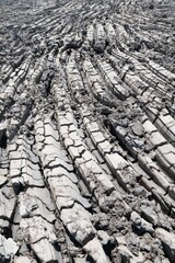 A texture and background of The fissures of the plowed and heated soil dry and crack.