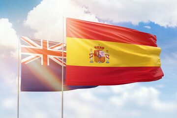 Sunny blue sky and flags of spain and new zealand