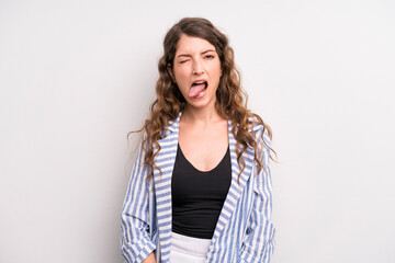young adult pretty woman with cheerful, carefree, rebellious attitude, joking and sticking tongue...