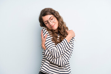young adult pretty woman feeling in love, smiling, cuddling and hugging self, staying single, being...