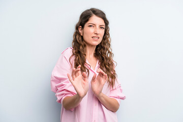 young adult pretty woman feeling disgusted and nauseous, backing away from something nasty, smelly...