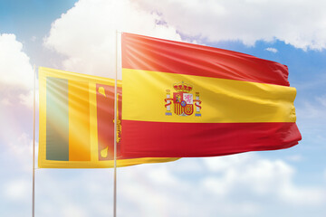 Sunny blue sky and flags of spain and sri lanka