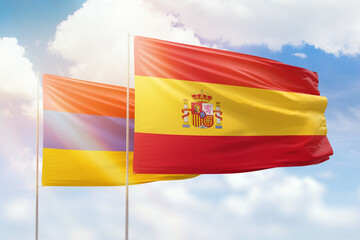 Sunny blue sky and flags of spain and armenia