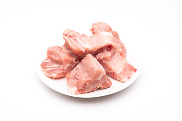 Raw Pork Bone Spine in white dish isolated on white