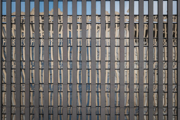 Office building with reflections in the glass facade of another building. High-quality photo