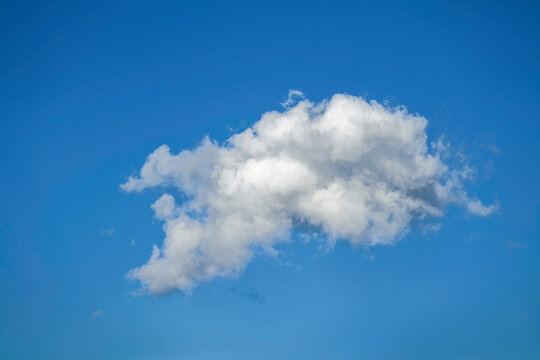 Beautiful cloudscape of nature single white cloud on blue sky background in the daytime. High-quality photo