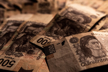 Money piled on a table, mexican peso currency