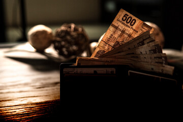 Money piled on a table, mexican peso currency