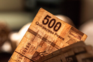 Money piled on a table, mexican peso currency