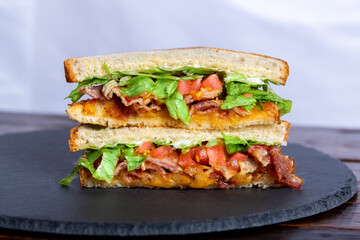 BLT Sandwich on White Bread laying on great slate tray