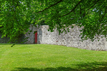 Gort, Co. Galway, Ireland: A red gate in the walled garden at Coole Park.